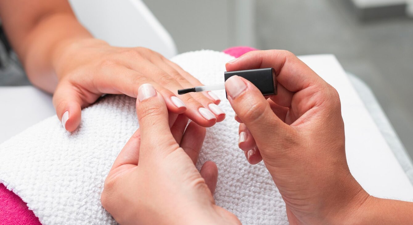 high-angle-woman-doing-manicure-client high-angle-woman-doing-manicure-client
